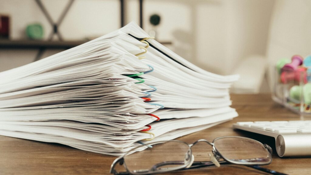 Stack of graded papers on a desk.