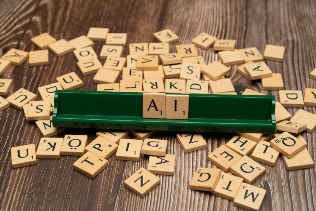 Scrabble tiles spelling out AI.